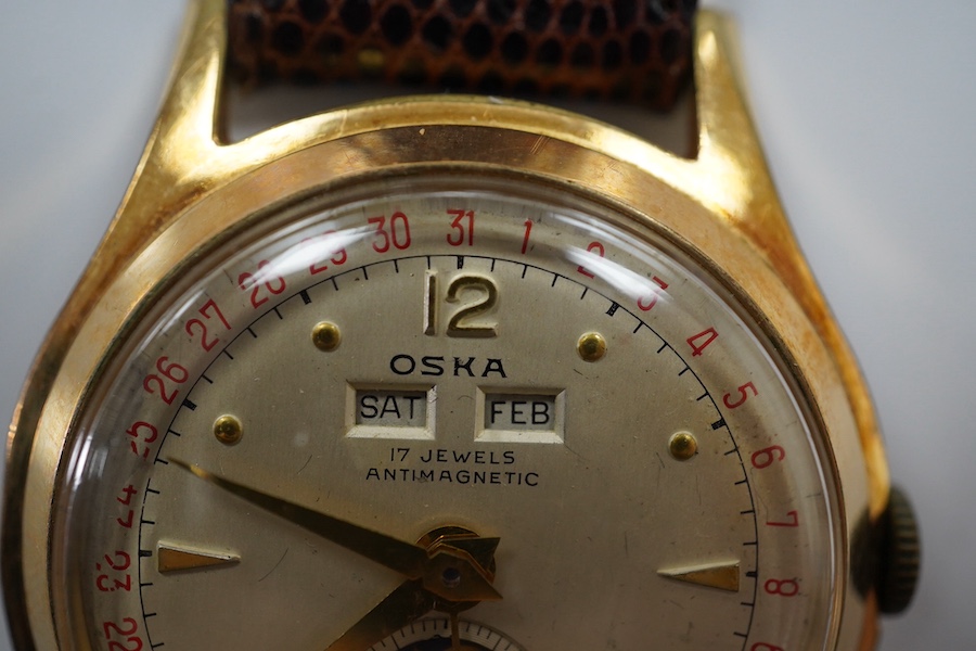 A gentleman's 1950's? steel and gold plated Oska Calendar Moonphase manual wind wrist watch, case diameter 32mm, on a later associated strap. Condition - poor to fair